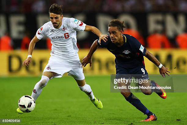 Filip Mladenovic of Koeln battles for the ball with Yussuf Poulsen of RB Leipzig during the Bundesliga match between 1. FC Koeln and RB Leipzig at...