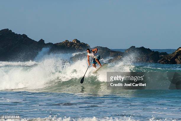 paddle board surfing in puerto escondido, mexico - puerto escondido stock pictures, royalty-free photos & images