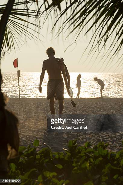 surfer at sunset in puerto escondido, mexico - puerto escondido stock pictures, royalty-free photos & images