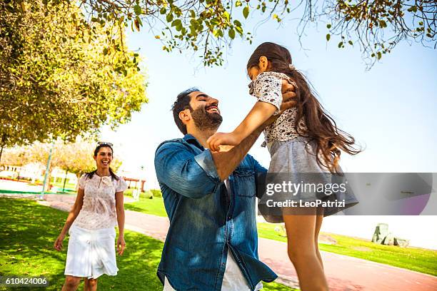 young family enjoying sunday outdoor in a city park - dubai family stock pictures, royalty-free photos & images