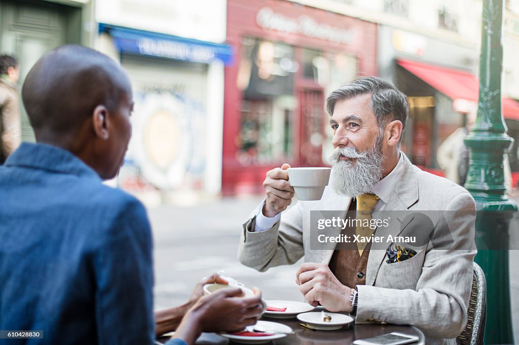 Français personnes qui ont un café dans un café de trottoir à Paris