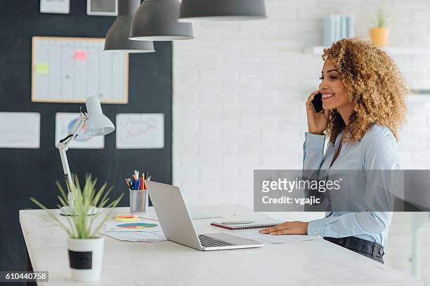 latina businesswoman working in her office - clean desk stock pictures, royalty-free photos & images
