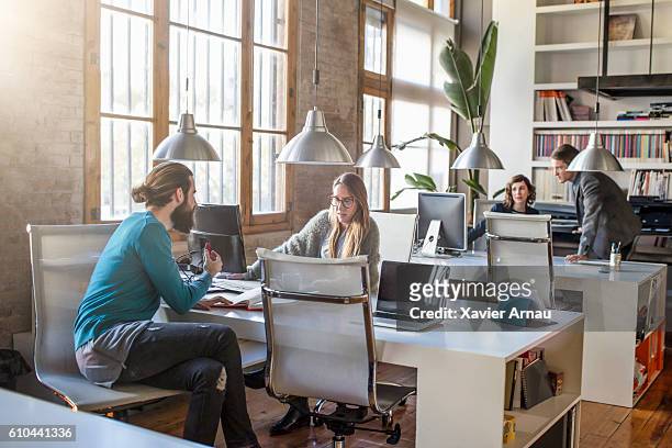 young creative business people working in the office - small office stock pictures, royalty-free photos & images