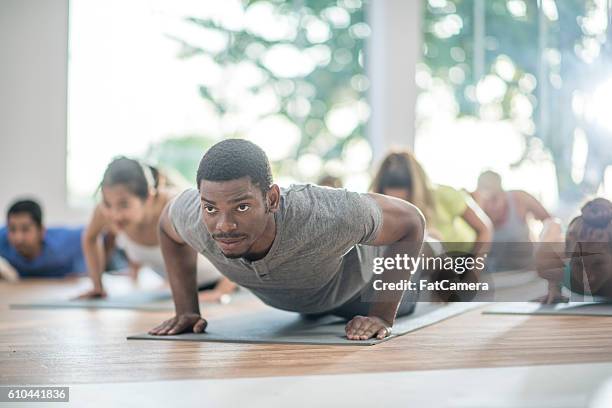 in plank position - yoga group stock pictures, royalty-free photos & images