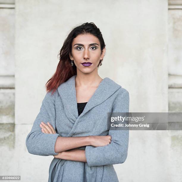 portrait of transgender female facing camera, arms folded - transgender stockfoto's en -beelden