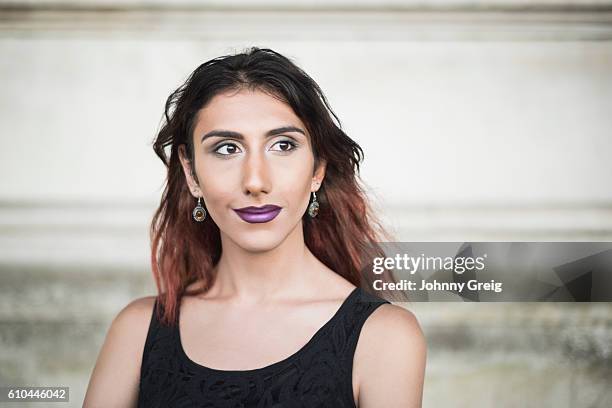 transgender female in black top, looking away - androgynous 個照片及圖片檔