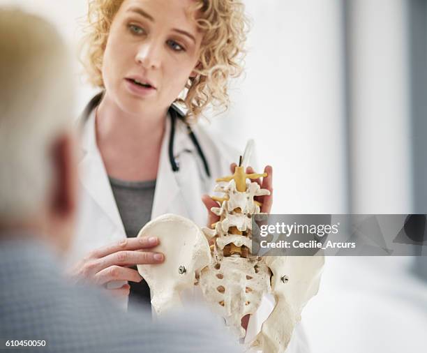 explaining his condition in detail - osteoporose imagens e fotografias de stock