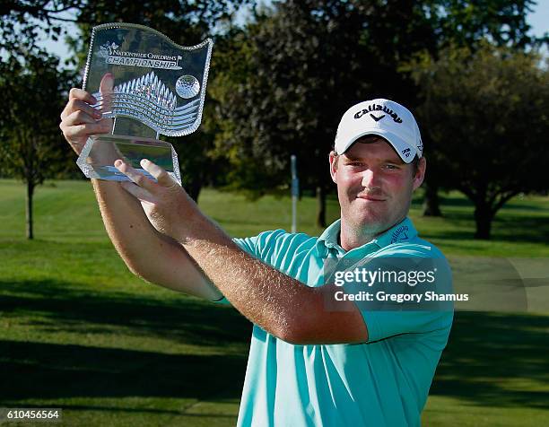 Grayson Murray poses with the championship trophy after winning the Web.com Tour Nationwide Children's Hospital Championship at The Ohio State...