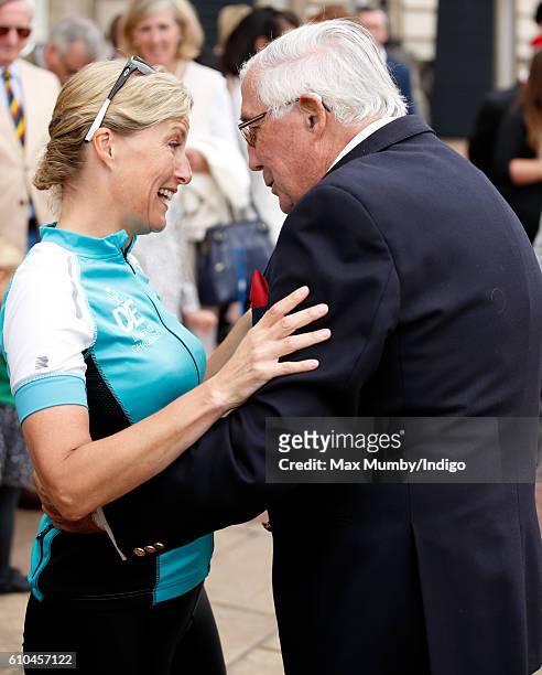 Sophie, Countess of Wessex greets her father Christopher Rhys-Jones after arriving at Buckingham Palace to complete her Diamond Challenge cycle ride...