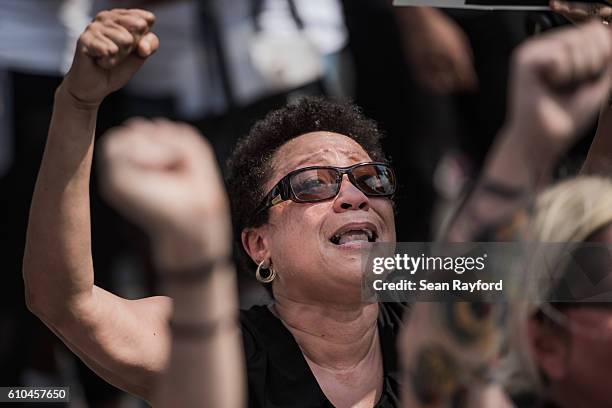 Demonstrators protest during the national anthem outside of Bank of America Stadium before an NFL football game between the Charlotte Panthers and...