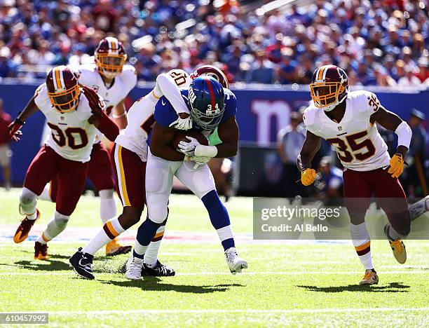 Shane Vereen of the New York Giants is tackled by Greg Toler of the Washington Redskins during their game at MetLife Stadium on September 25, 2016 in...