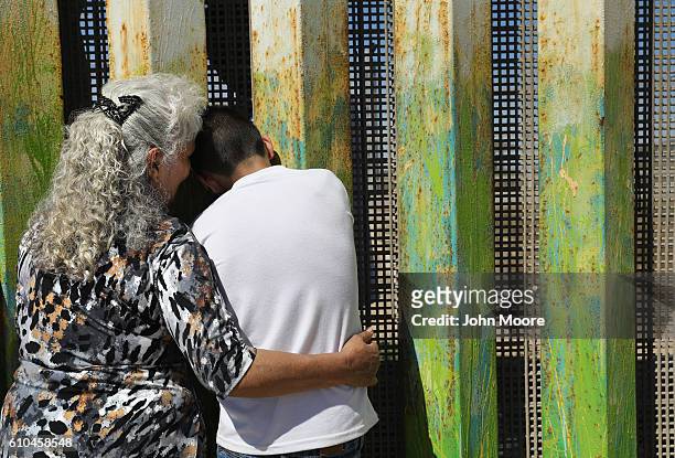 Maria Rodriguez Torres embraces a grandchild after seeing her other grandchildren for the first time through the U.S.-Mexico border fence on...