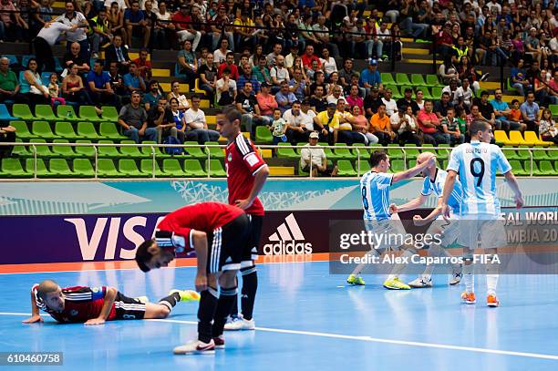 Santiago Basile of Argentina celebrates with his teammates Damian Stazzone and Cristian Borruto after scoring his team's third goal during the FIFA...