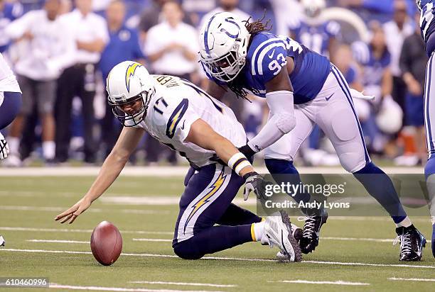 Philip Rivers of the San Diego Chargers is tackled by Erik Walden of the Indianapolis Colts after fumbling the ball in the second quarter of the game...