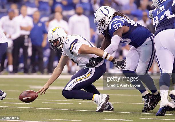 Philip Rivers of the San Diego Chargers fumbles the ball after being sacked by Erik Walden of the Indianapolis Cotls during the game at Lucas Oil...