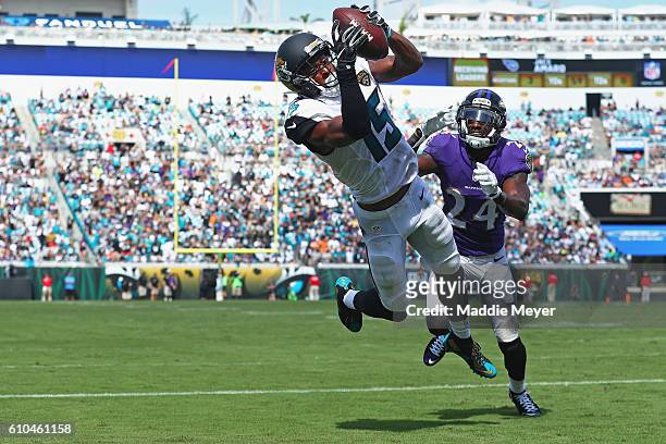 Allen Robinson of the Jacksonville Jaguars catches a touchdown pass in front of Kyle Arrington of the Baltimore Ravens at EverBank Field on September...