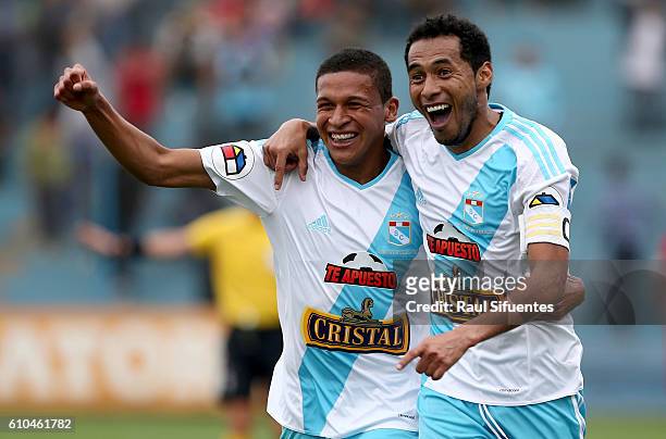 Carlos Lobaton of Sporting Cristal celebrates with teammate Fernando Pacheco after scoring the first goal of his team against Juan Aurich during a...