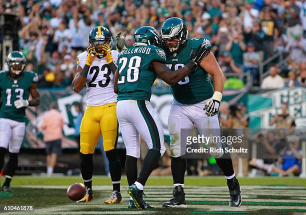 Wendell Smallwood of the Philadelphia Eagles celebrates his rushing-touchdown with teammate Allen Barbre as Mike Mitchell of the Pittsburgh Steelers...