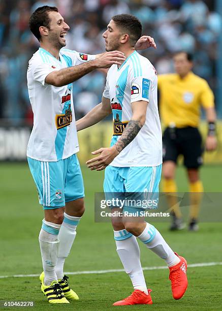 Santiago Silva of Sporting Cristal celebrates with teammate Horacio Calcaterra after scoring the third goal of his team during a match between...