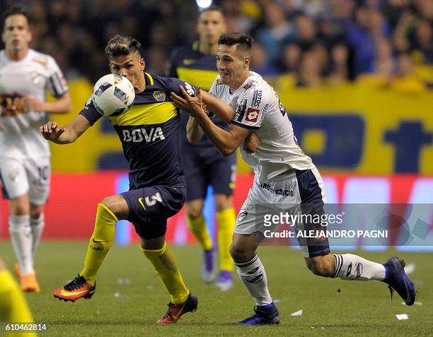 Boca Juniors' defender Jonathan Silva vies for the ball with Quilmes' midfielder Hernan Da Campo during their Argentina First Division football...