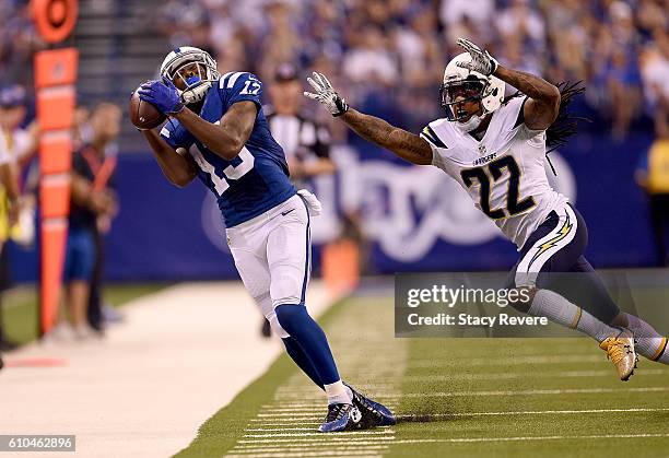 Hilton of the Indianapolis Colts catches a pass while being covered by Jason Verrett of the San Diego Chargers during the game at Lucas Oil Stadium...