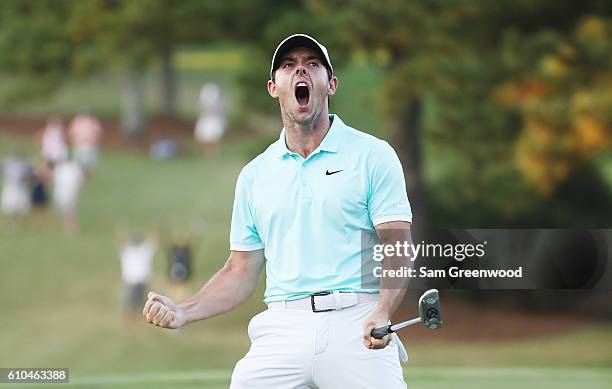 Rory McIlroy of Northern Ireland celebrates a birdie putt to defeat Ryan Moore on the fourth playoff hole to win the TOUR Championship and clinch the...
