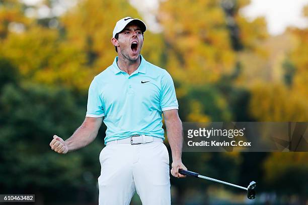 Rory McIlroy of Northern Ireland celebrates a birdie putt to defeat Ryan Moore on the fourth playoff hole to win the TOUR Championship and clinch the...