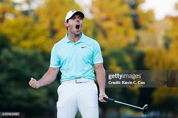 Rory McIlroy of Northern Ireland celebrates a birdie putt to defeat Ryan Moore on the fourth playoff hole to win the TOUR Championship and clinch the...