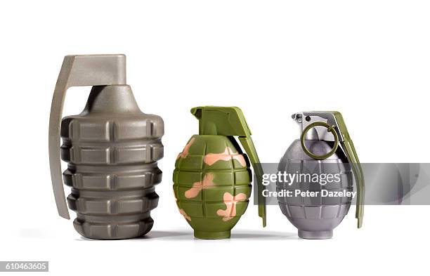 three hand grenades on white - hand grenade stock pictures, royalty-free photos & images