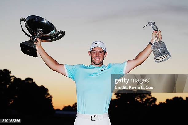 Rory McIlroy of Northern Ireland poses with the FedExCup and TOUR Championship trophies after his victory over Ryan Moore with a birdie on the fourth...