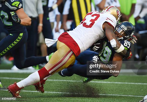 Inside linebacker NaVorro Bowman of the San Francisco 49ers tackles wide receiver Doug Baldwin of the Seattle Seahawks during the third quarter of...