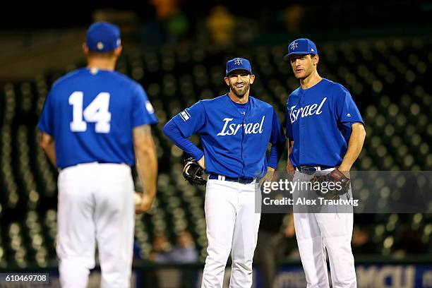 Josh Zeid and Nate Freiman of Team Israel joke with Cody Decker during Game 6 of the 2016 World Baseball Classic Qualifier at MCU Park on Sunday,...