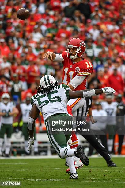 Quarterback Alex Smith of the Kansas City Chiefs throws the ball just ahead of the sack threat from outside linebacker Lorenzo Mauldin of the New...