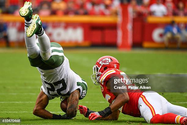 Running back Matt Forte of the New York Jets is up ended by inside linebacker Derrick Johnson of the Kansas City Chiefs at Arrowhead Stadium during...