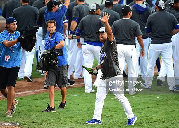 Manager Dave Roberts of the Los Angeles Dodgers reacts after a 4-3 win over the Colorado Rockies to clinch the National League West Division at...