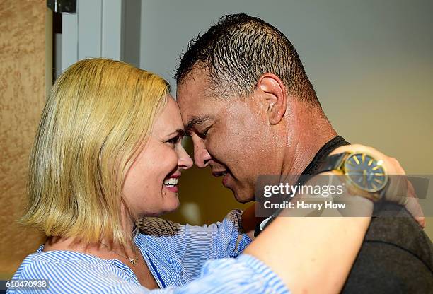 Manager Dave Roberts of the Los Angeles Dodgers celebrates a 4-3 win over the Colorado Rockies to clinch the National League West Division with wife...