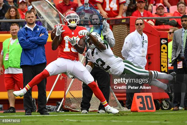 Wide receiver Jeremy Maclin of the Kansas City Chiefs attempts to catch a pass with cornerback Juston Burris of the New York Jets in tight coverage...