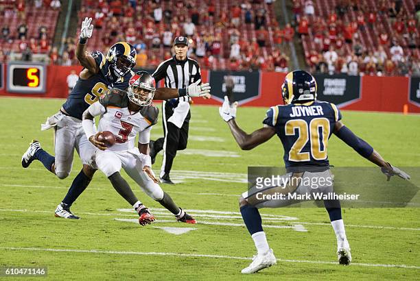 Los Angeles Rams defensive end Robert Quinn sneaks up behind Tampa Bay Buccaneers quarterback James Winston as he scrambles from inside the 10 yard...