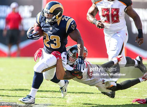 Los Angeles Rams running back Benny Cunningham drags Tampa Bay Buccaneers safety Chris Conte during the first half of their NFL football game at...