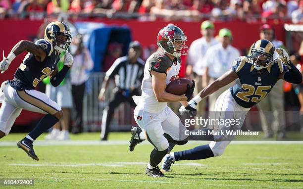 Tampa Bay Buccaneers wide receiver Adam Humphries runs after a reception as Los Angeles Rams Troy Hill and T.J. McDonald pursue during the first half...