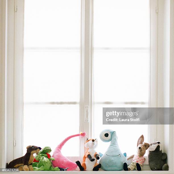 colourful stuffed toys on windowsill - stuffed toy stock pictures, royalty-free photos & images