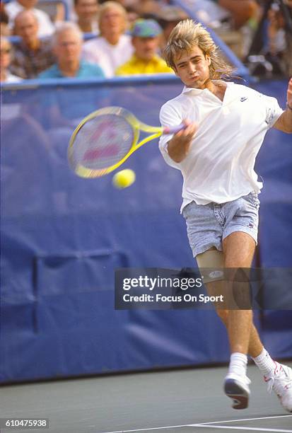 Andre Agassi of the United States hits a return during the Men's 1989 US Open Tennis Championships circa 1989 at the USTA Tennis Center in the Queens...