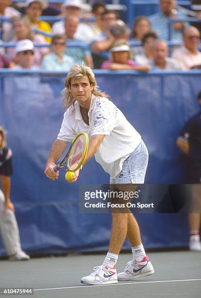 Andre Agassi of the United States serves during the Men's 1989 US Open Tennis Championships circa 1989 at the USTA Tennis Center in the Queens...