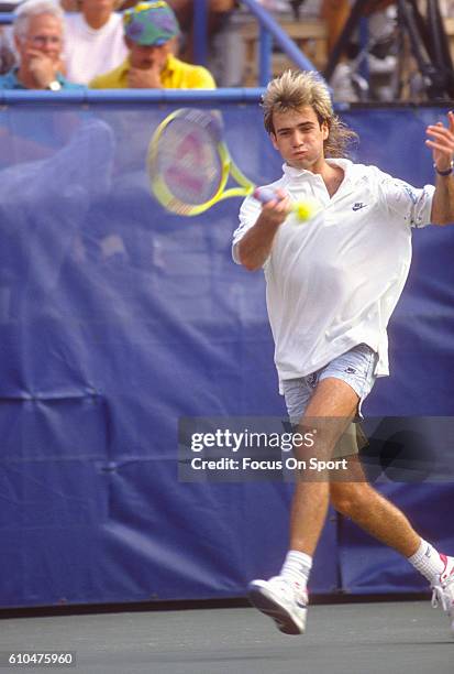 Andre Agassi of the United States hits a return during the Men's 1989 US Open Tennis Championships circa 1989 at the USTA Tennis Center in the Queens...
