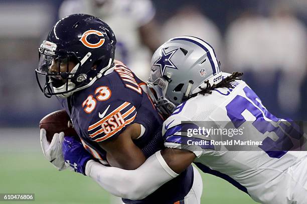 Brandon Carr of the Dallas Cowboys tackles Jeremy Langford of the Chicago Bears in the third quarter during a game between the Dallas Cowboys and the...