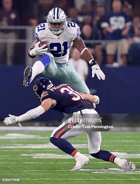 Ezekiel Elliott of the Dallas Cowboys hurdles Chris Prosinski of the Chicago Bears while carrying the ball in the fourth quarter at AT&T Stadium on...