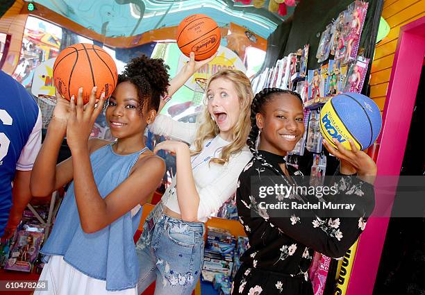 Actresses Riele Downs, Hana Heyes, and Reiya Downs play games with guests at the Mini Hoops Booth during the 17th Annual Mattel Party on the Pier on...