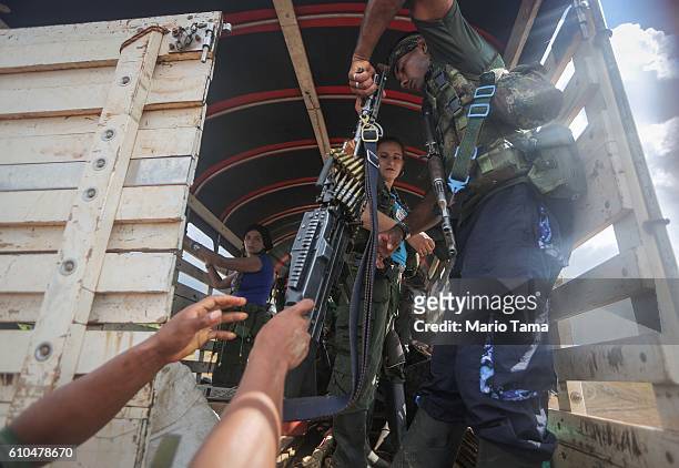 Revolutionary Armed Forces of Colombia rebels depart their camp with their weapons following the 10th Guerrilla Conference in the remote Yari plains...