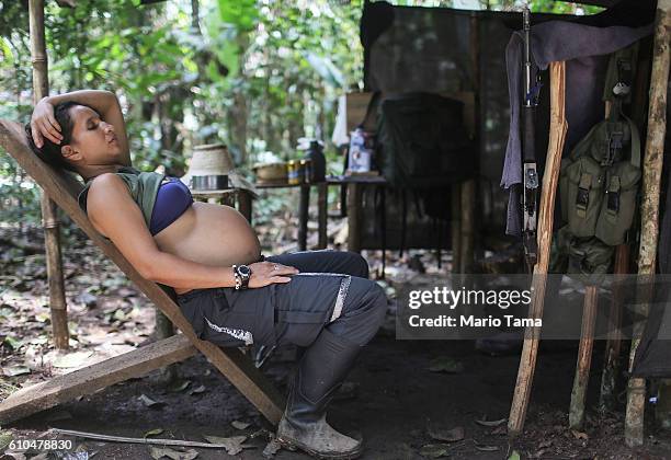 Rebel Tatiana, almost seven months pregnant, rests in camp following the 10th Guerrilla Conference in the remote Yari plains where the peace accord...