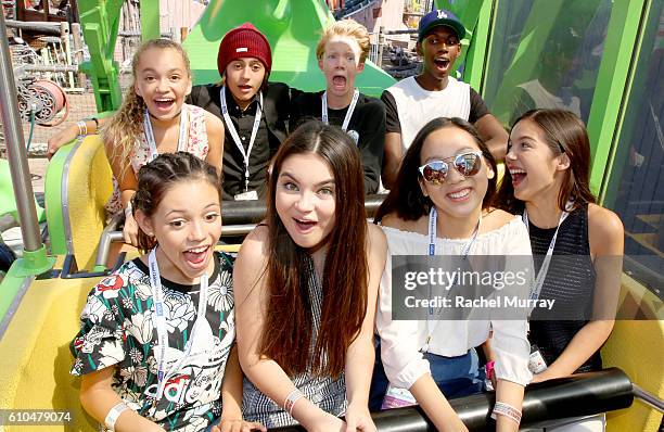 Actors Jillian Shea Spaeder, Isaak Presley, Cody Veith, guest, Jenna Ortega, Landry Bender, Madison Hu, and Olivia Rodrigo go on rides together...